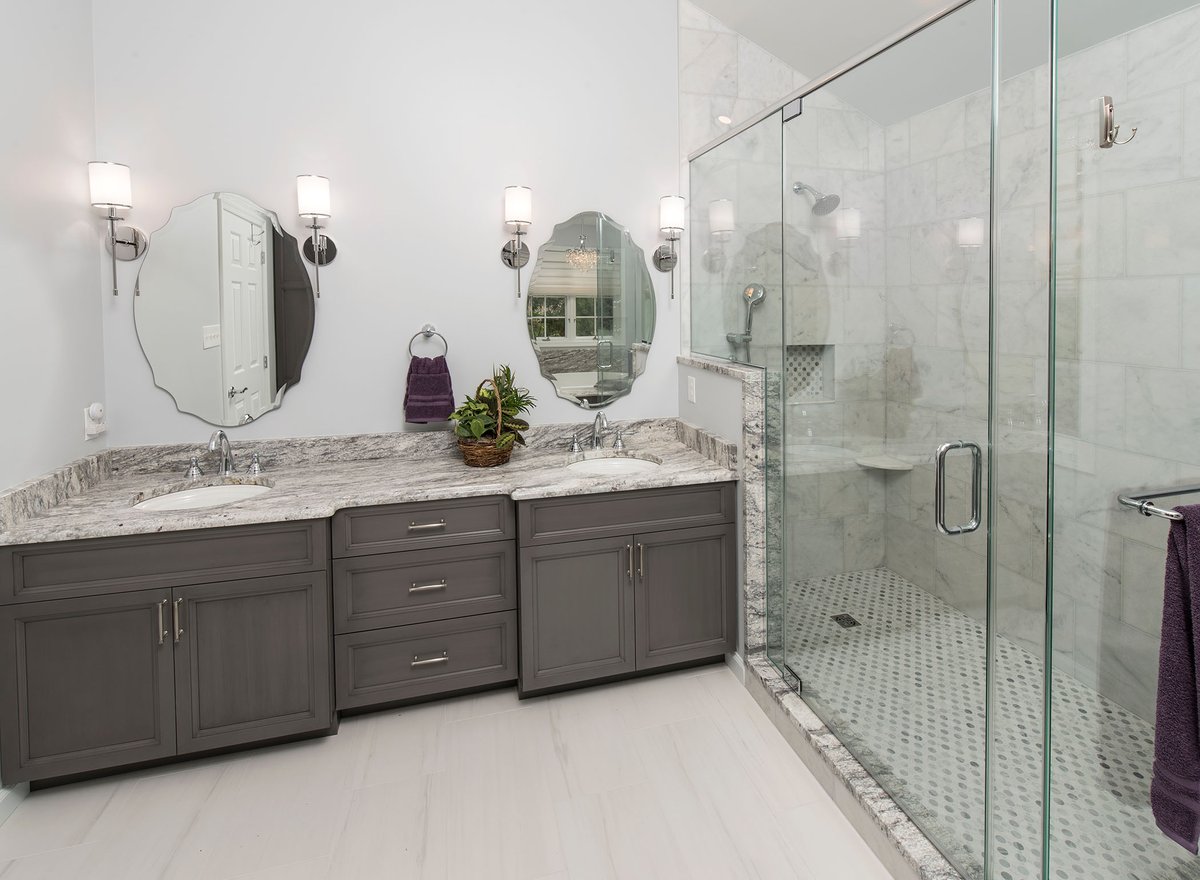 elegant bathroom remodel with double vanity and glass shower enclosure